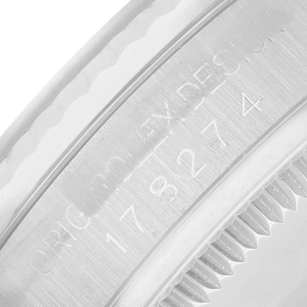 The image shows a close-up of the bezel and rehaut engraving of a Rolex Datejust 178274 Women's Stainless Steel White Dial watch.