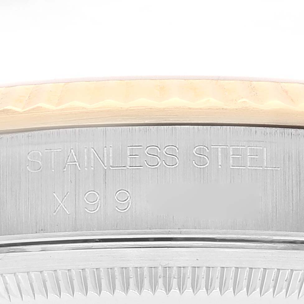 This image features a close-up of the side of a Rolex Datejust 16233 Men's Steel and Gold (two tone) White Dial 16233 Men's Steel and Gold (two tone) White Dial watch, showing text engraved on the stainless steel casing.