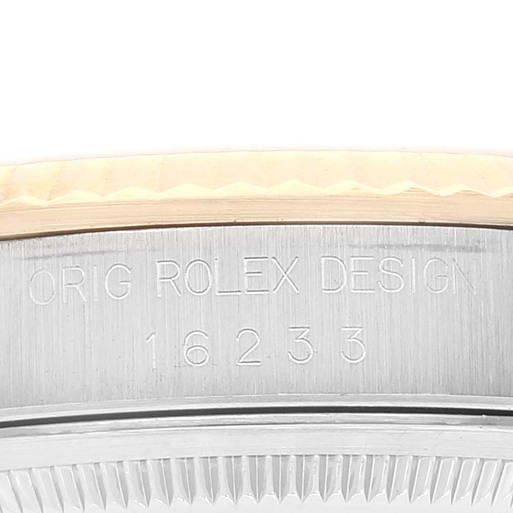 The image shows a close-up of the side of a Rolex Datejust 16233 Men's Steel and Gold (two tone) White Dial 16233 Men's Steel and Gold (two tone) White Dial watch, focusing on the model number and fluted bezel.