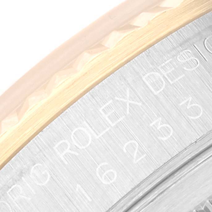 The image shows a close-up of the bezel and part of the engraved inner ring of a Rolex Datejust 16233 Men's Steel and Gold (two tone) Silver Dial 16233 Men's Steel and Gold (two tone) Silver Dial watch.