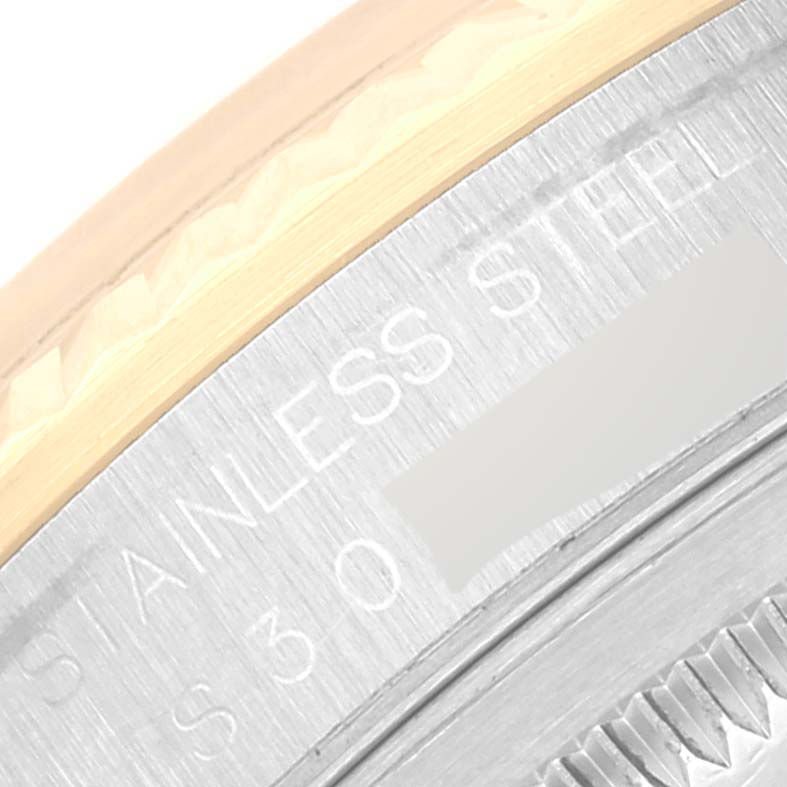 The image shows a close-up angle of the edge of the bezel and case back of the Rolex Datejust 16233 Men's Steel and Gold (two tone) Silver Dial 16233 Men's Steel and Gold (two tone) Silver Dial watch, highlighting the stainless steel engraving.