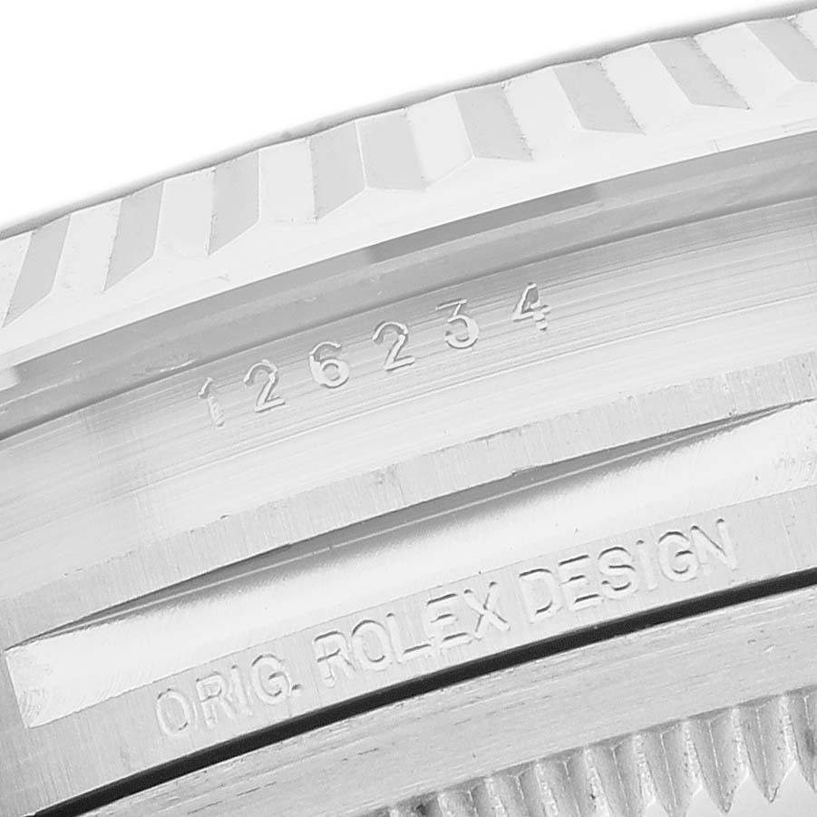 The image shows a close-up of the Rolex Datejust 126234 Men's Stainless Steel Purple Dial's fluted bezel and engraved model details.