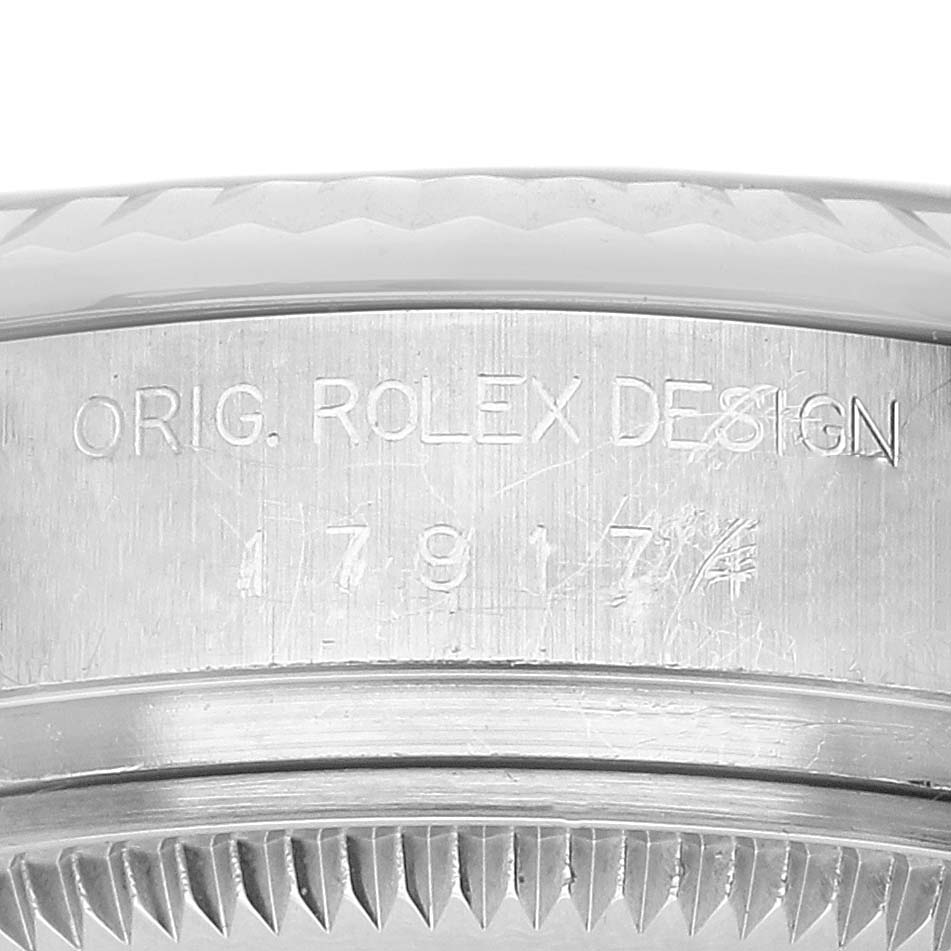 The image shows an angled close-up of a Rolex Datejust 179174 Women's Stainless Steel Silver Dial watch, highlighting the engraved case side with "ORIG. ROLEX DESIGN."