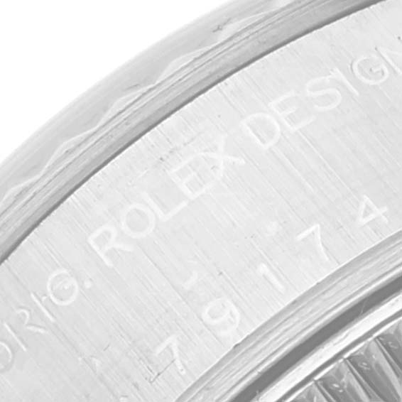 The image shows a close-up of the engraved case side of a Rolex Datejust 79174 Women's Stainless Steel White Dial 79174 Women's Stainless Steel White Dial watch.