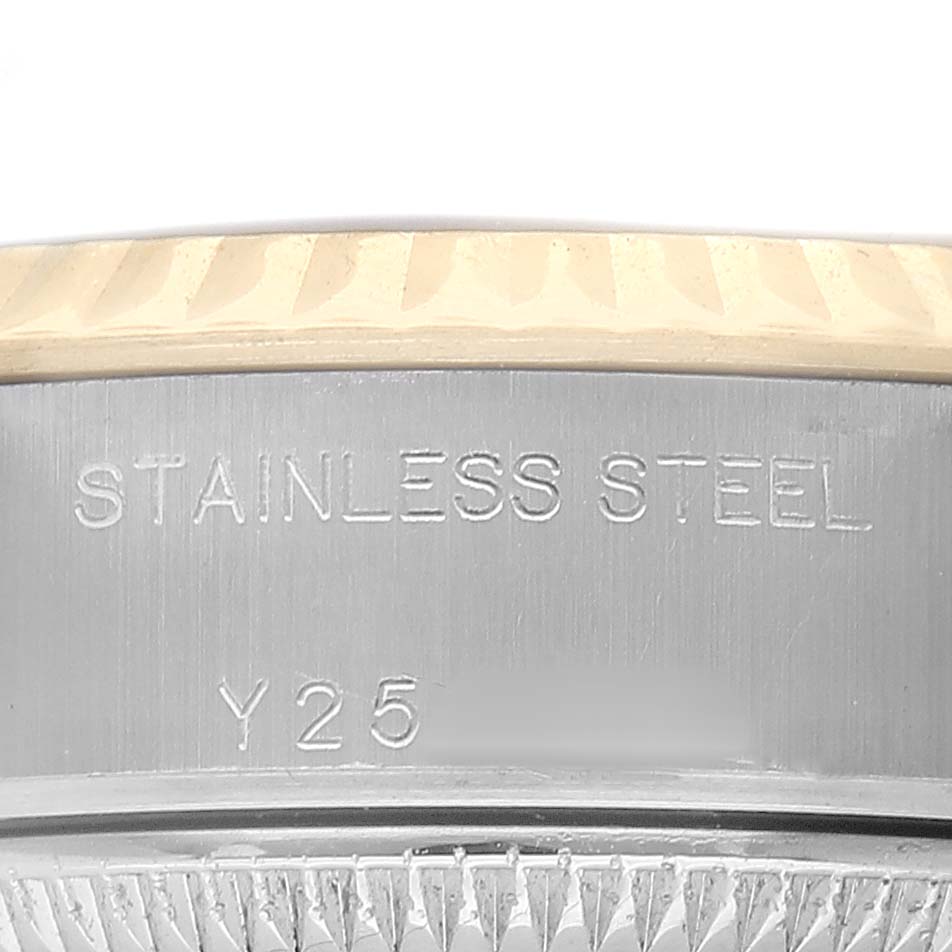 The image shows a close-up of the side of a Rolex Datejust 79173 Women's Steel and Gold (two tone) Black Dial, highlighting the stainless steel body and engravings.