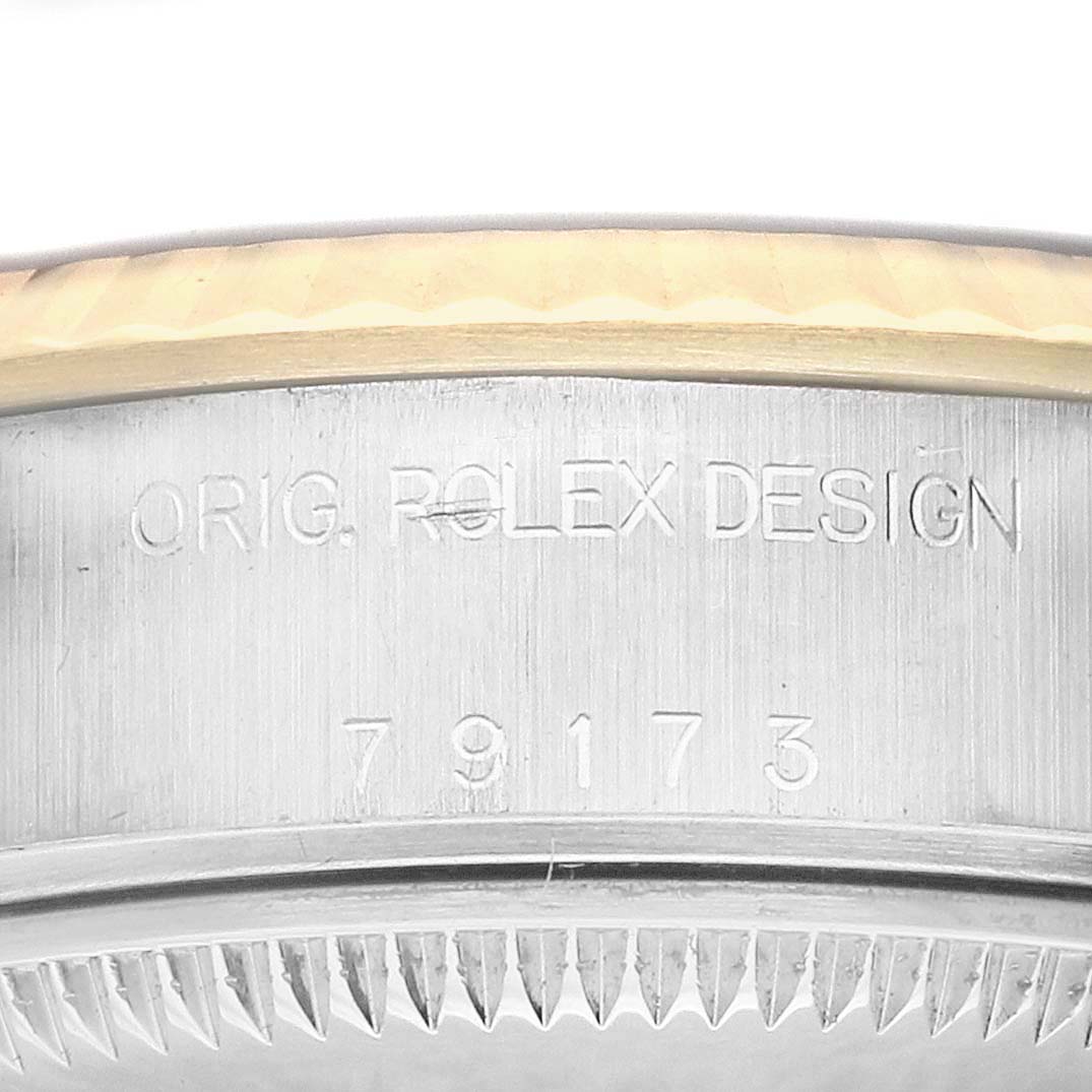 The image shows a close-up of the side of a Rolex Datejust 79173 Women's Steel and Gold (two tone) Champagne Dial, displaying the engraving "ORIG. ROLEX DESIGN" and the model number.