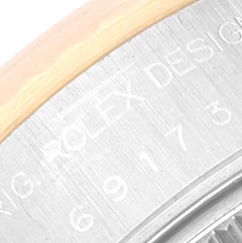 This close-up image shows a portion of the bezel and the case with engravings of the Rolex Datejust 69173 Women's Steel and Gold (two tone) Champagne Dial 69173 Women's Steel and Gold (two tone) Champagne Dial model.