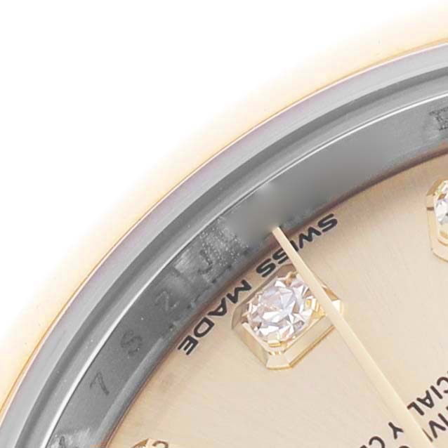 The image shows a close-up of the Rolex Datejust 279163 Women's Steel and Gold (two tone) Champagne Dial watch, highlighting part of the dial with diamond markers and text.