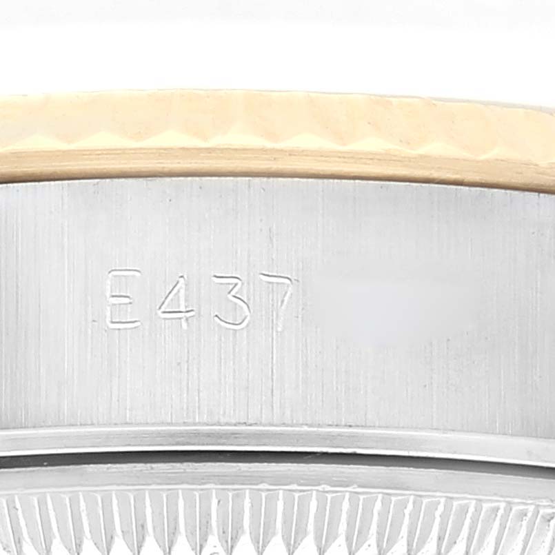 The image shows a close-up of the side and part of the bezel of a Rolex Datejust 69173 Women's Steel and Gold (two tone) Champagne Dial 69173 Women's Steel and Gold (two tone) Champagne Dial watch, displaying an engraved serial number.