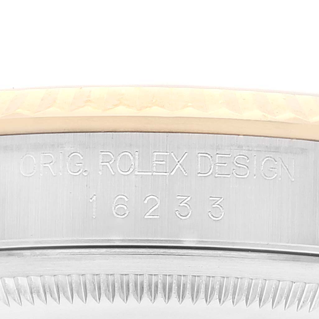 The image shows a close-up of the engraved case side and bezel of a Rolex Datejust 16233 Men's Steel and Gold (two tone) Champagne Dial 16233 Men's Steel and Gold (two tone) Champagne Dial model with the design number 16233.