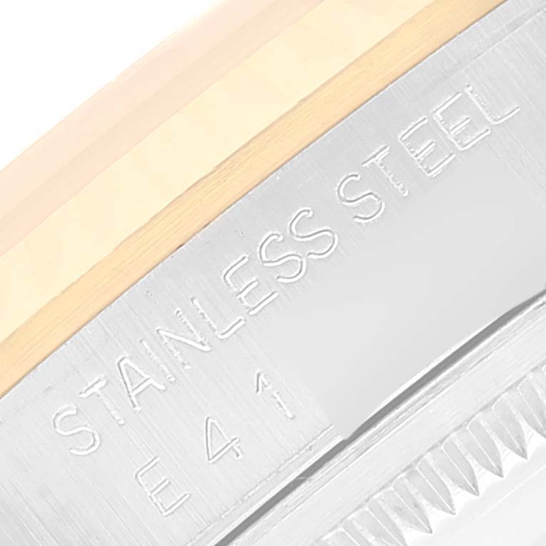 The image shows a close-up of the engraved "STAINLESS STEEL" text on a Rolex Datejust 16233 Men's Steel and Gold (two tone) Champagne Dial 16233 Men's Steel and Gold (two tone) Champagne Dial watch, focusing on the case edge.