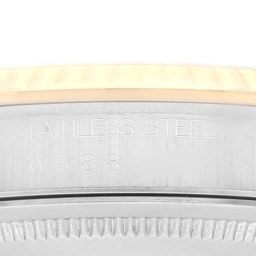 This image displays a close-up of the side of a Rolex Datejust 16233 Men's Steel and Gold (two tone) Champagne Dial 16233 Men's Steel and Gold (two tone) Champagne Dial watch, highlighting the stainless steel portion with engraved text.