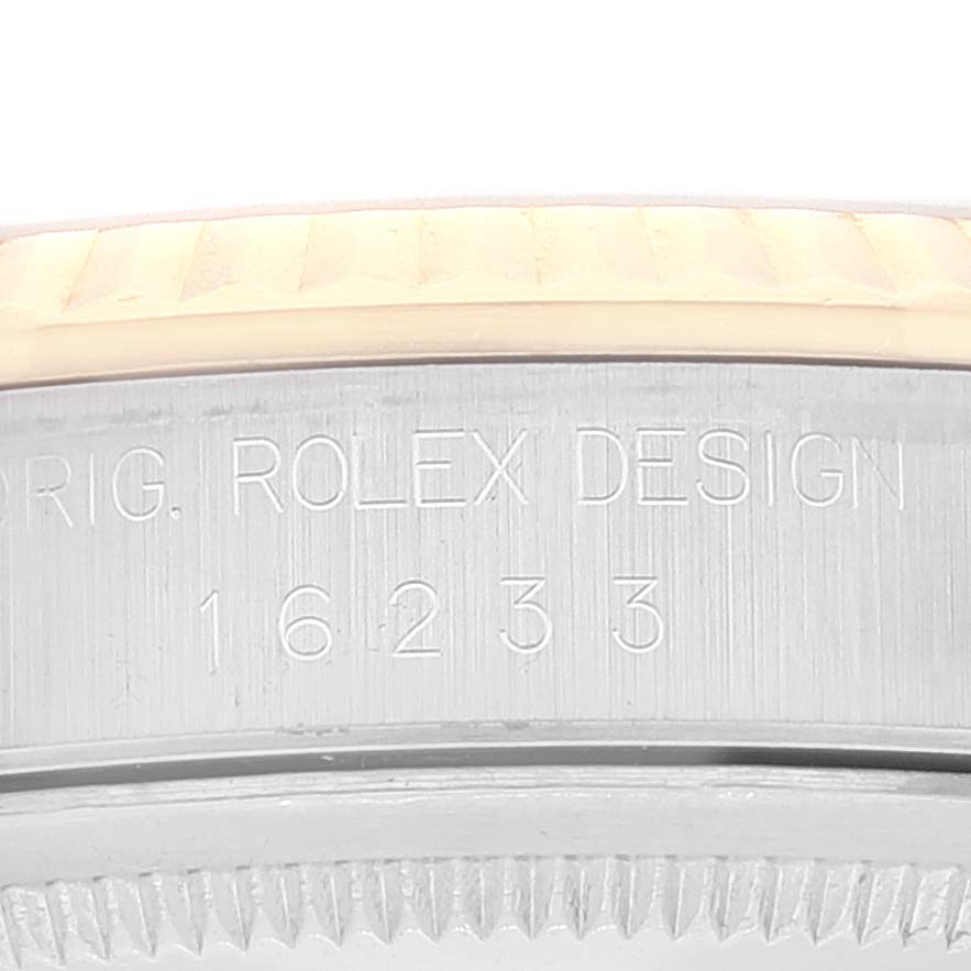 This image shows the side of the Rolex Datejust 16233 Men's Steel and Gold (two tone) Champagne Dial 16233 Men's Steel and Gold (two tone) Champagne Dial 16233 model case, highlighting the engraved model number and "ROLEX DESIGN" text.