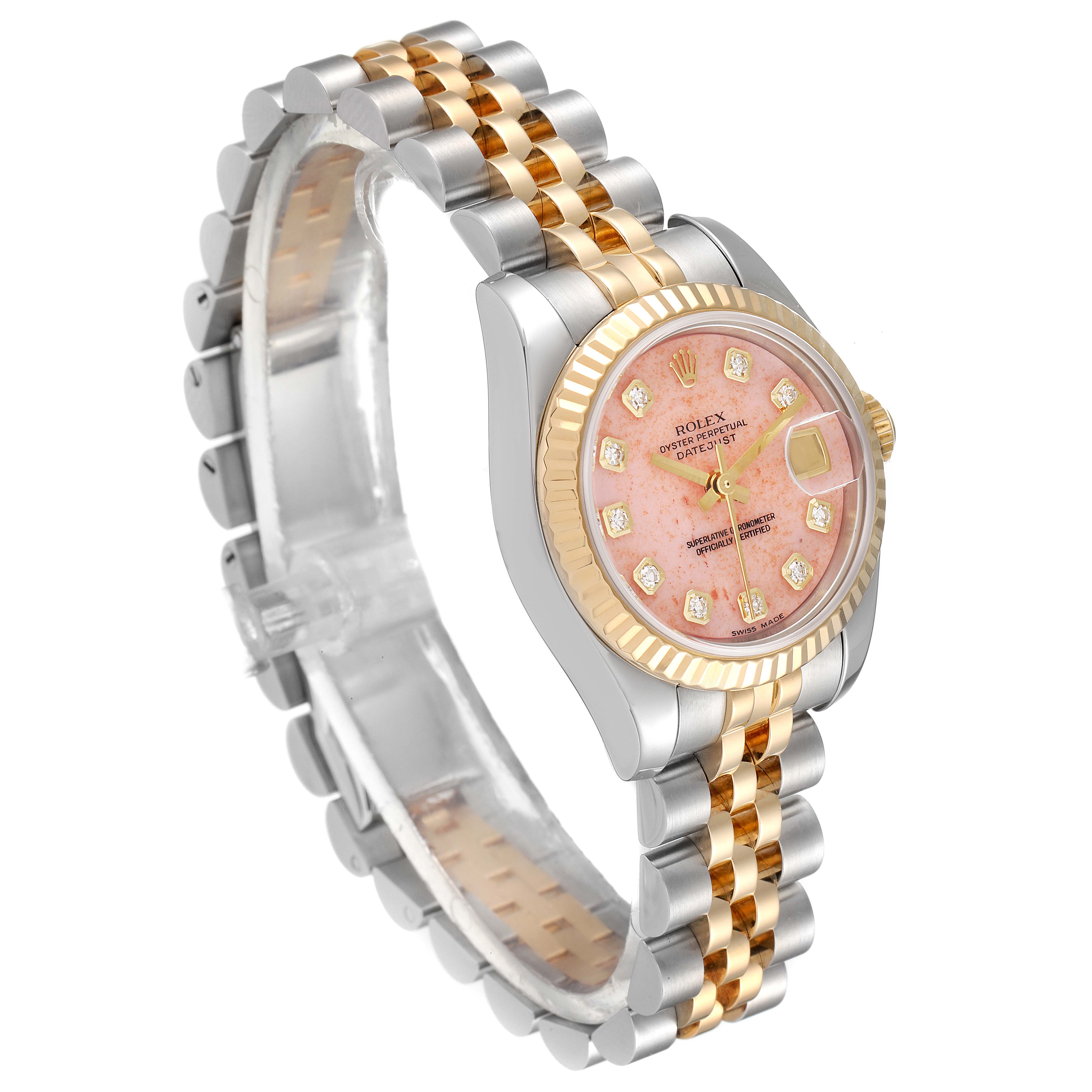 The image shows a Rolex Datejust 179173 Women's Steel and Gold (two tone) Pink Dial 179173 Women's Steel and Gold (two tone) Pink Dial watch at an oblique angle, displaying its dial, bezel, and two-tone bracelet.