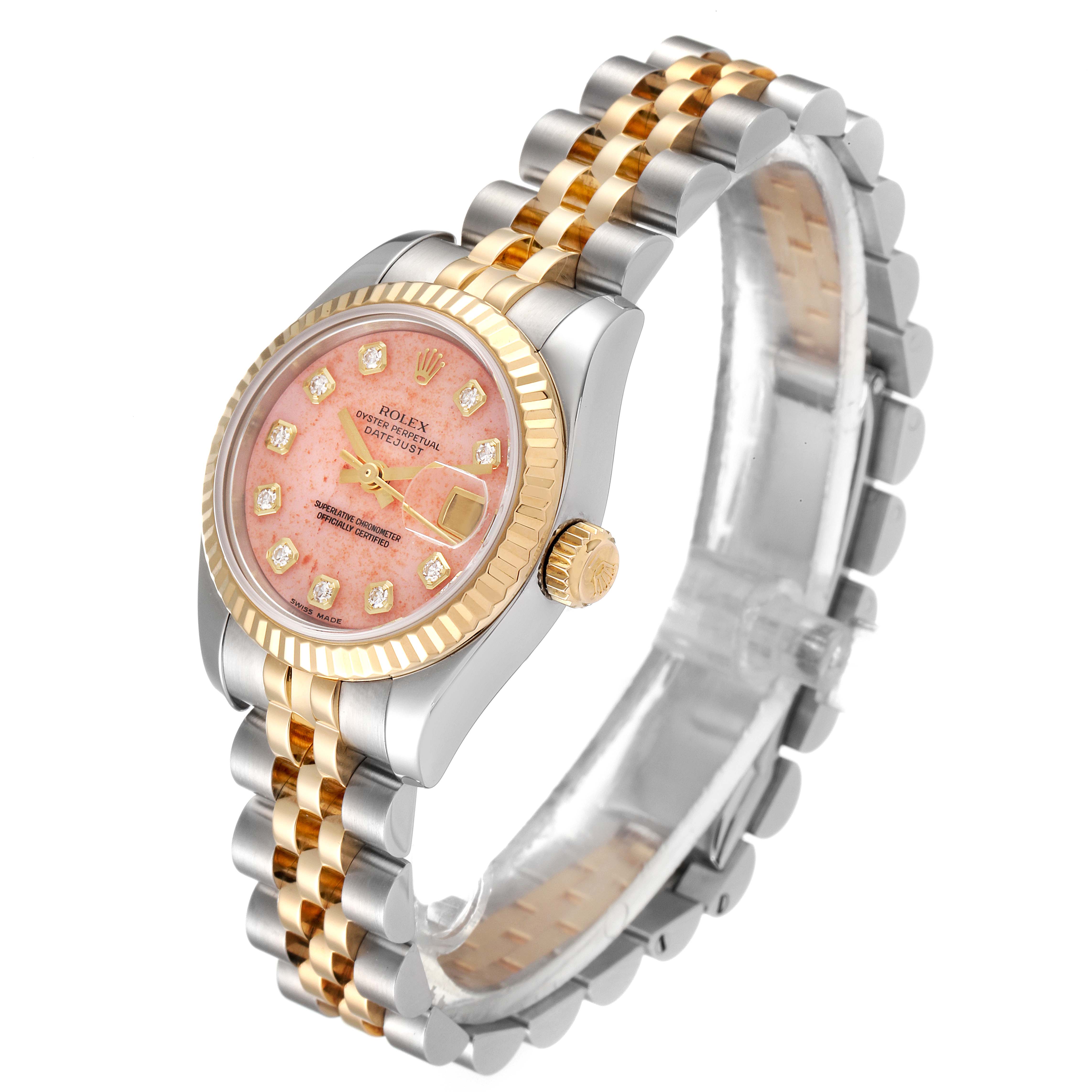 The Rolex Datejust 179173 Women's Steel and Gold (two tone) Pink Dial 179173 Women's Steel and Gold (two tone) Pink Dial watch is shown at an angled view, displaying its pink dial, two-tone jubilee bracelet, and fluted bezel.