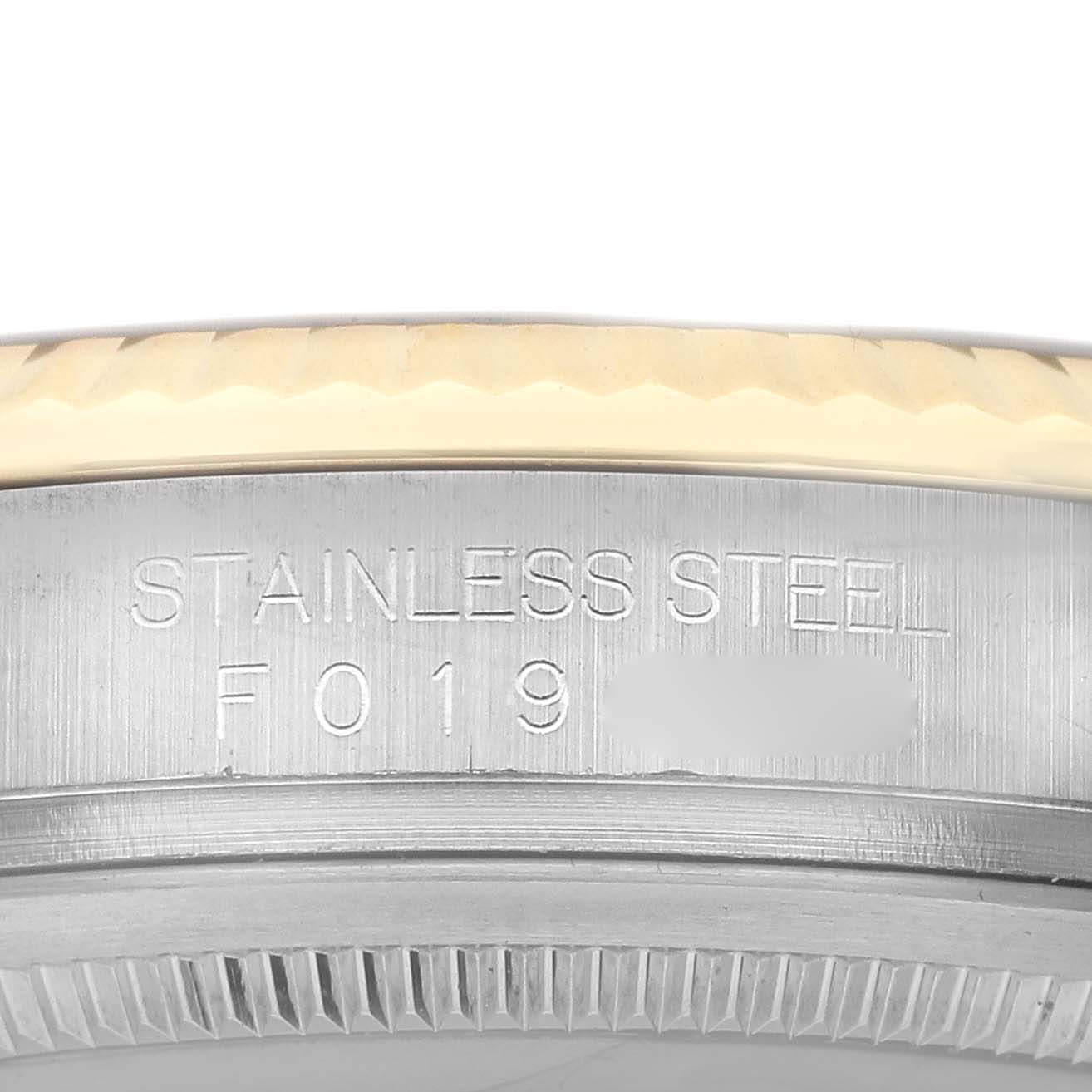 The image shows a close-up side view of the Rolex Datejust 116233 Men's Steel and Gold (two tone) Blue Dial's case, highlighting the stainless steel marking and the bezel edge.