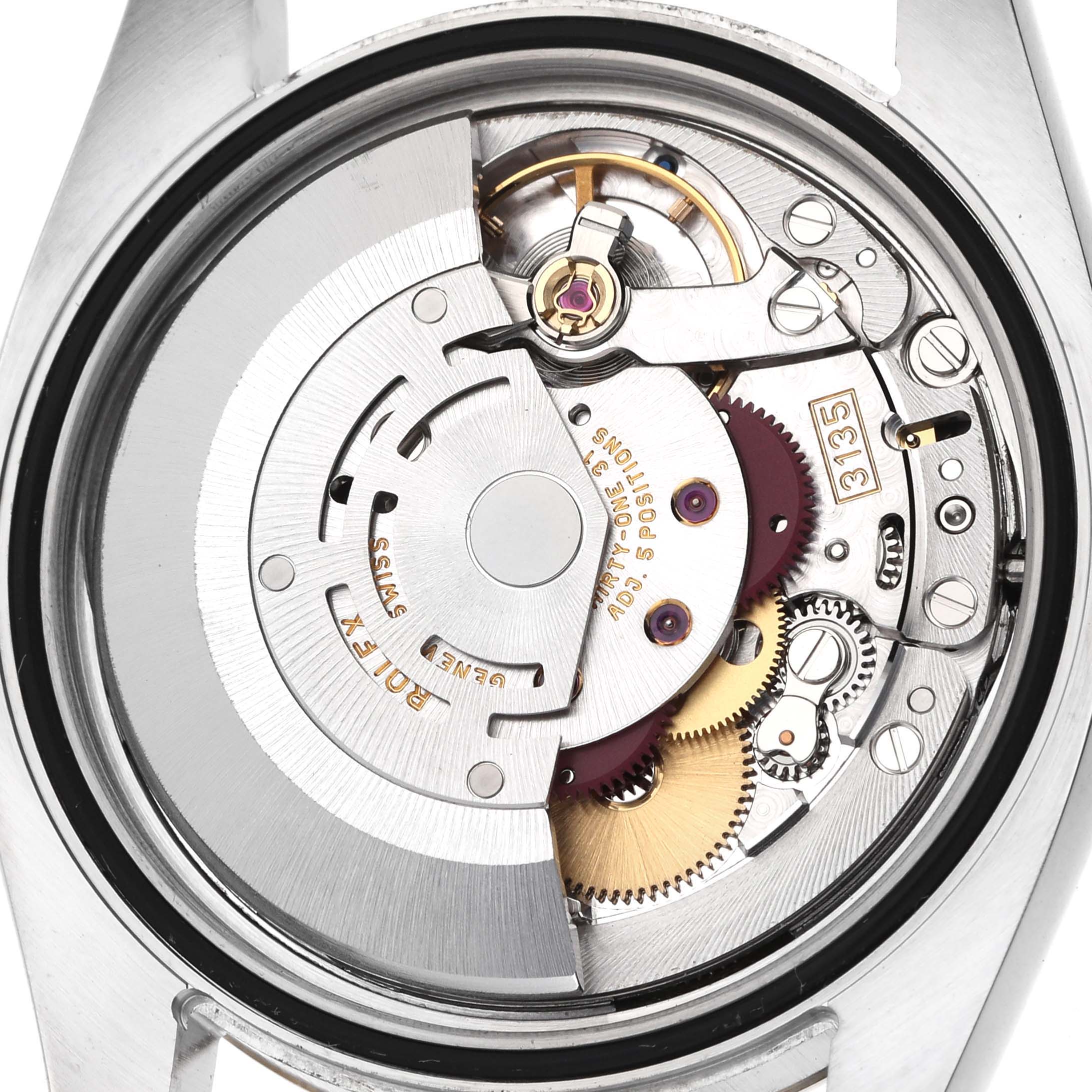 The image shows the movement mechanism of the Rolex Datejust 116233 Men's Steel and Gold (two tone) Blue Dial, viewed from the back with internal components visible.