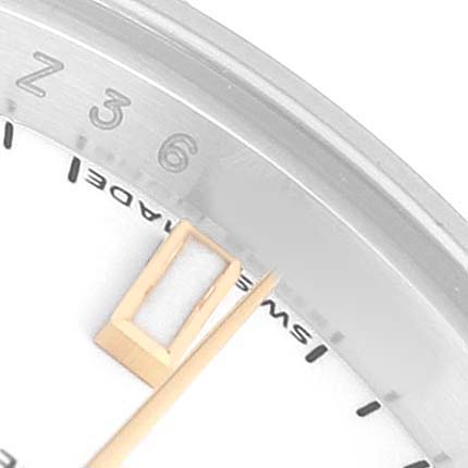 This image shows a close-up of the Rolex Datejust 179173 Women's Steel and Gold (two tone) White Dial watch, highlighting the dial, minute markers, and part of the hand.