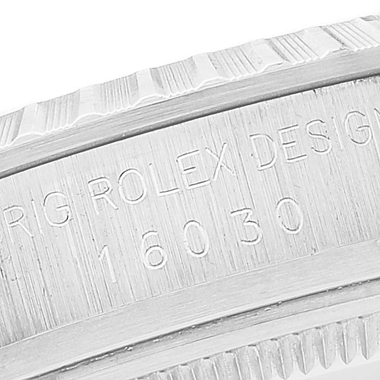 This close-up image shows the side bezel and reference engraving of the Rolex Vintage Collection 16030 Men's Stainless Steel White Dial 16030 Men's Stainless Steel White Dial model 16030.