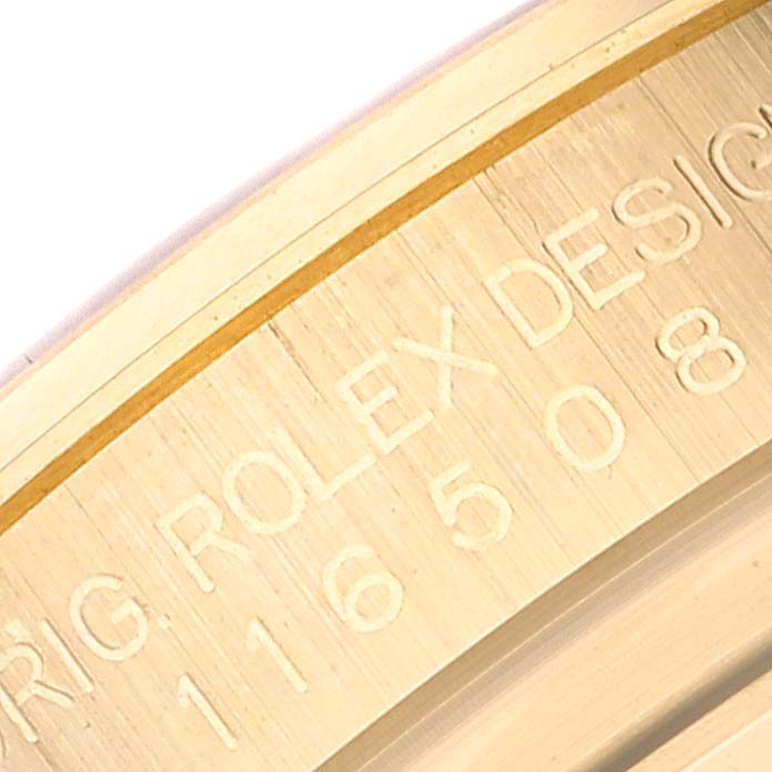 This close-up image shows the engraved inner bezel of the Rolex Daytona 116508 Men's Yellow Gold Green Dial 116508 Men's Yellow Gold Green Dial model.