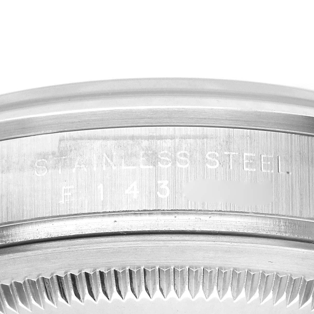 The image shows a close-up of the stainless steel back and edge grooves of a Rolex Explorer 114270 Men's Stainless Steel Black Dial watch case.