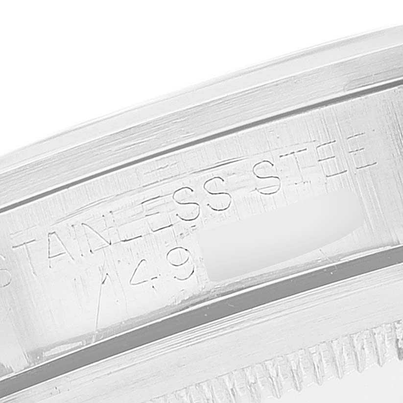 The image shows a close-up of the engraved case back edge of a Rolex Vintage Collection 1016 Men
s Stainless Steel Black Dial 1016 Men
s Stainless Steel Black Dial watch made of stainless steel.