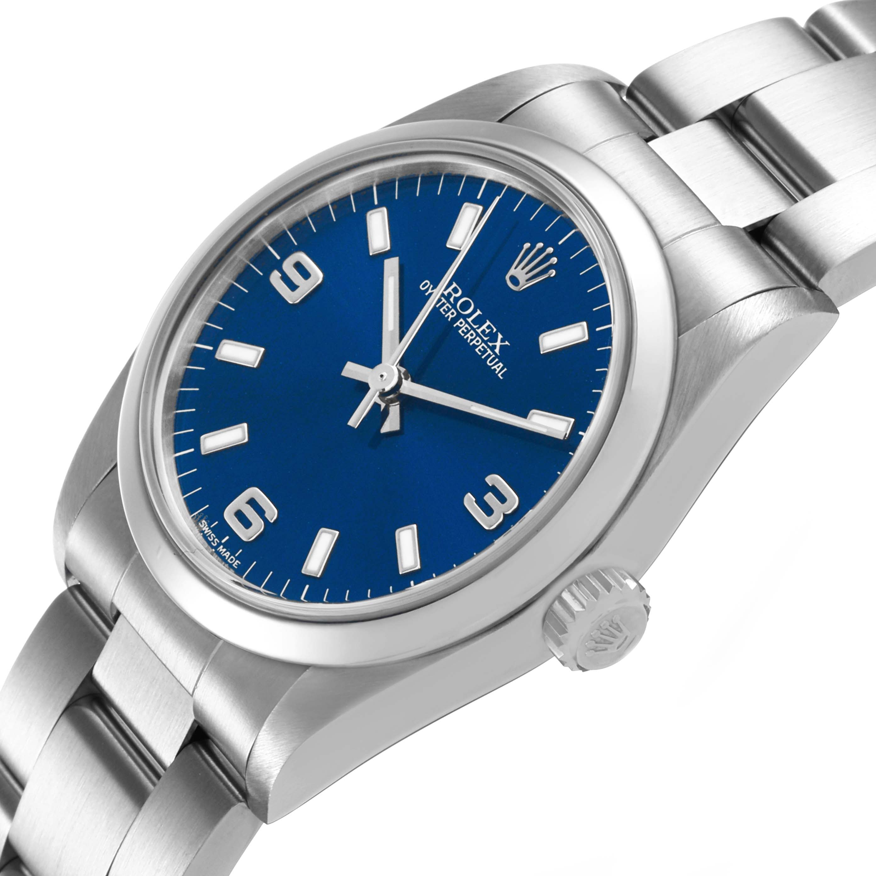 The Rolex Oyster Perpetual 77080 Women's Stainless Steel Blue Dial watch is angled to show the blue dial, crown, and part of the stainless steel bracelet.