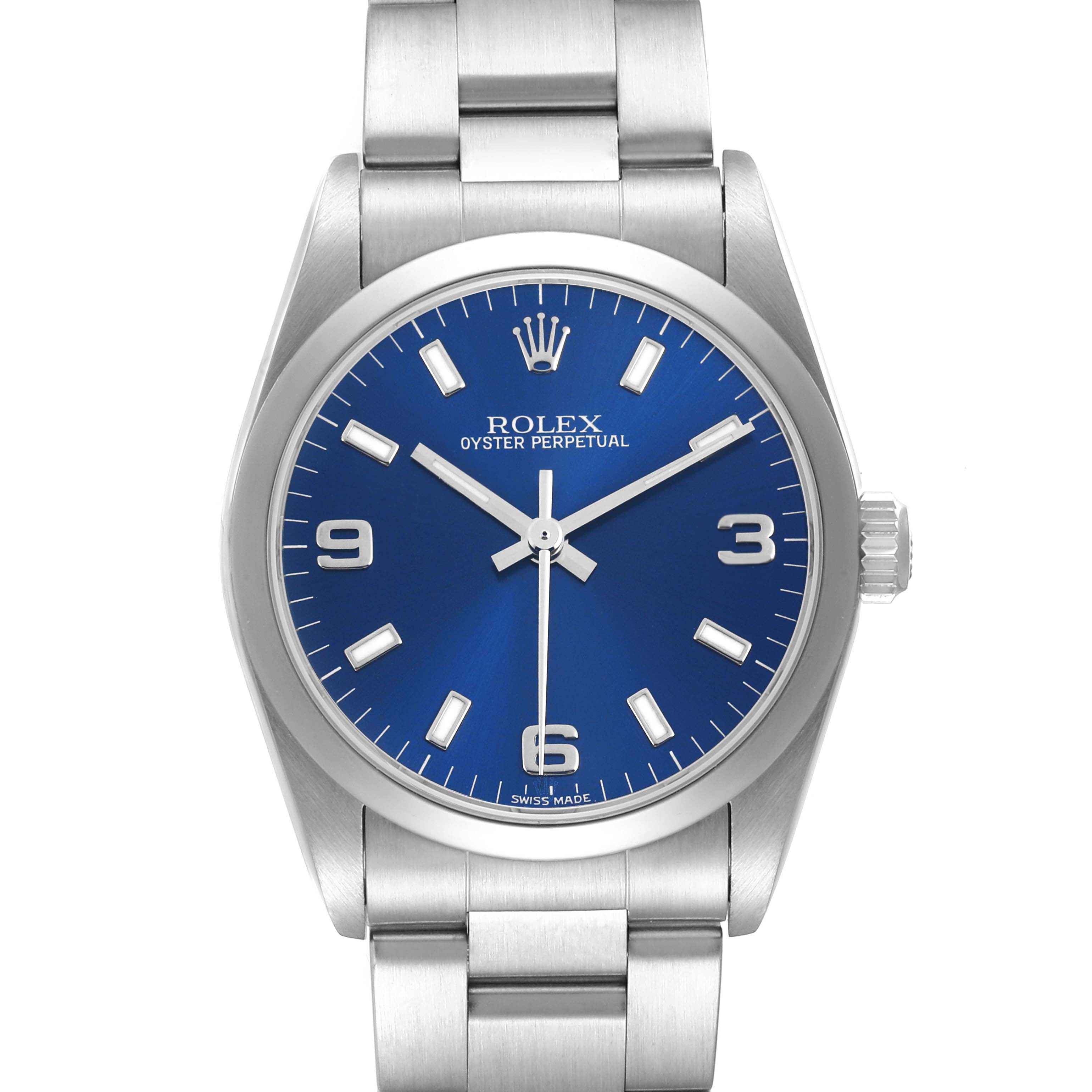 The Rolex Oyster Perpetual 77080 Women's Stainless Steel Blue Dial watch is shown from a front angle, displaying the dial, bezel, and bracelet.