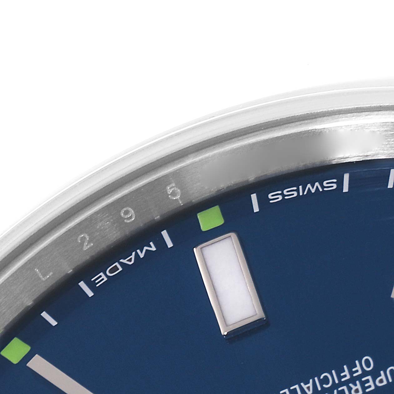 The image shows a close-up of the dial and markers of a Rolex Oyster Perpetual 114300 Men's Stainless Steel Blue Dial 114300 Men's Stainless Steel Blue Dial watch.