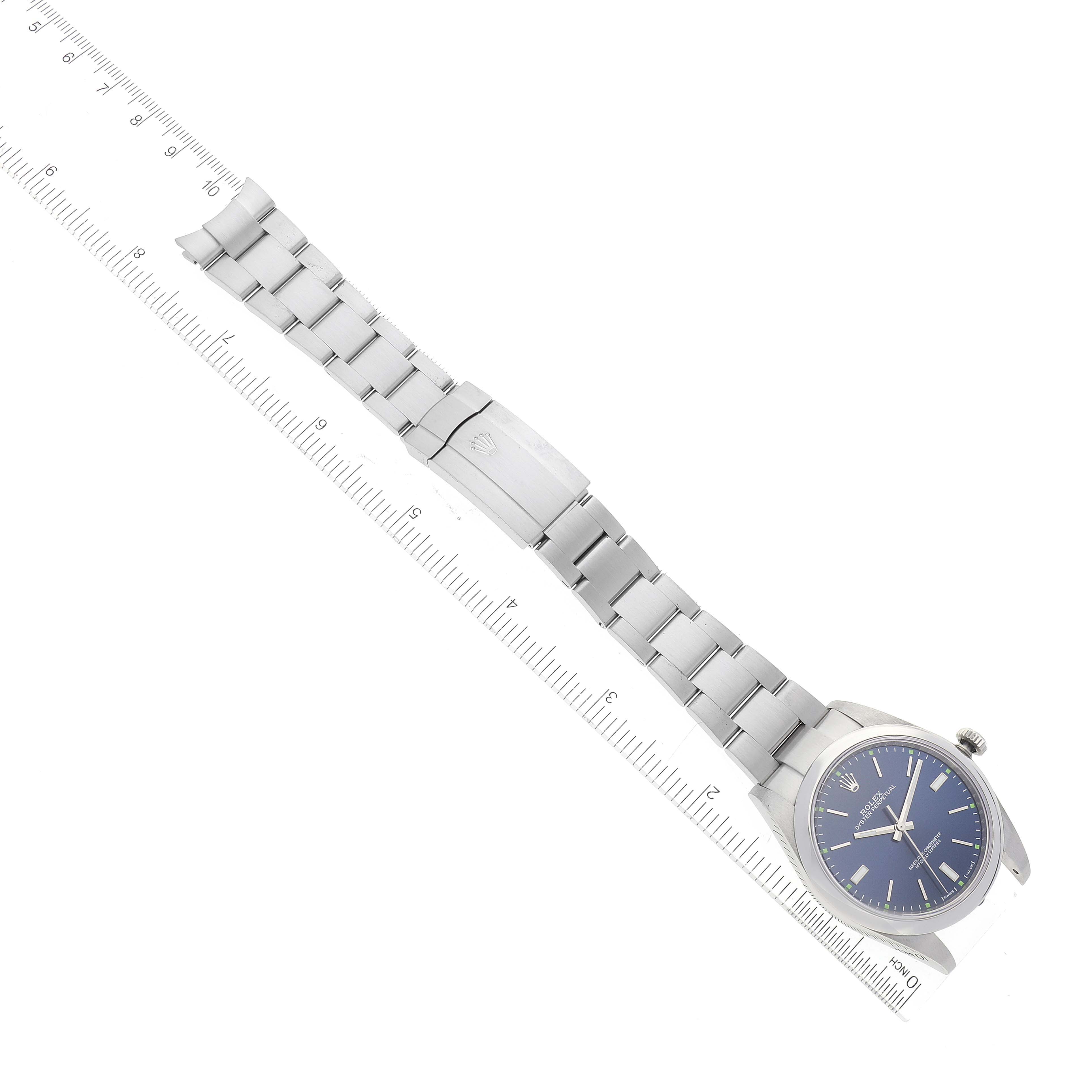 The image shows a side angle of a Rolex Oyster Perpetual 114300 Men's Stainless Steel Blue Dial 114300 Men's Stainless Steel Blue Dial watch with a blue dial and its stainless steel bracelet.