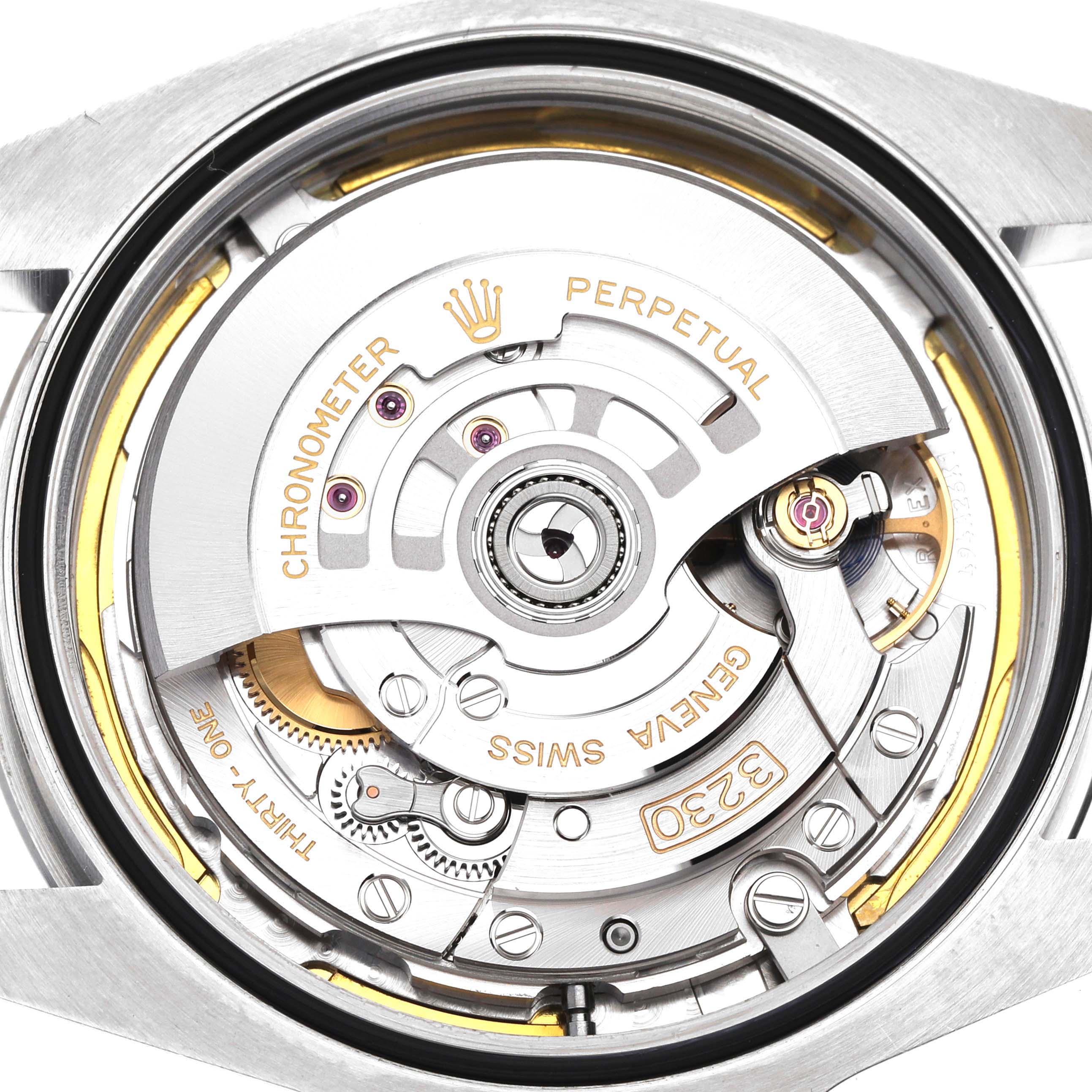 The image shows the back view of a Rolex Air-King 126900 Men's Stainless Steel Black Dial, highlighting its internal movement and components.