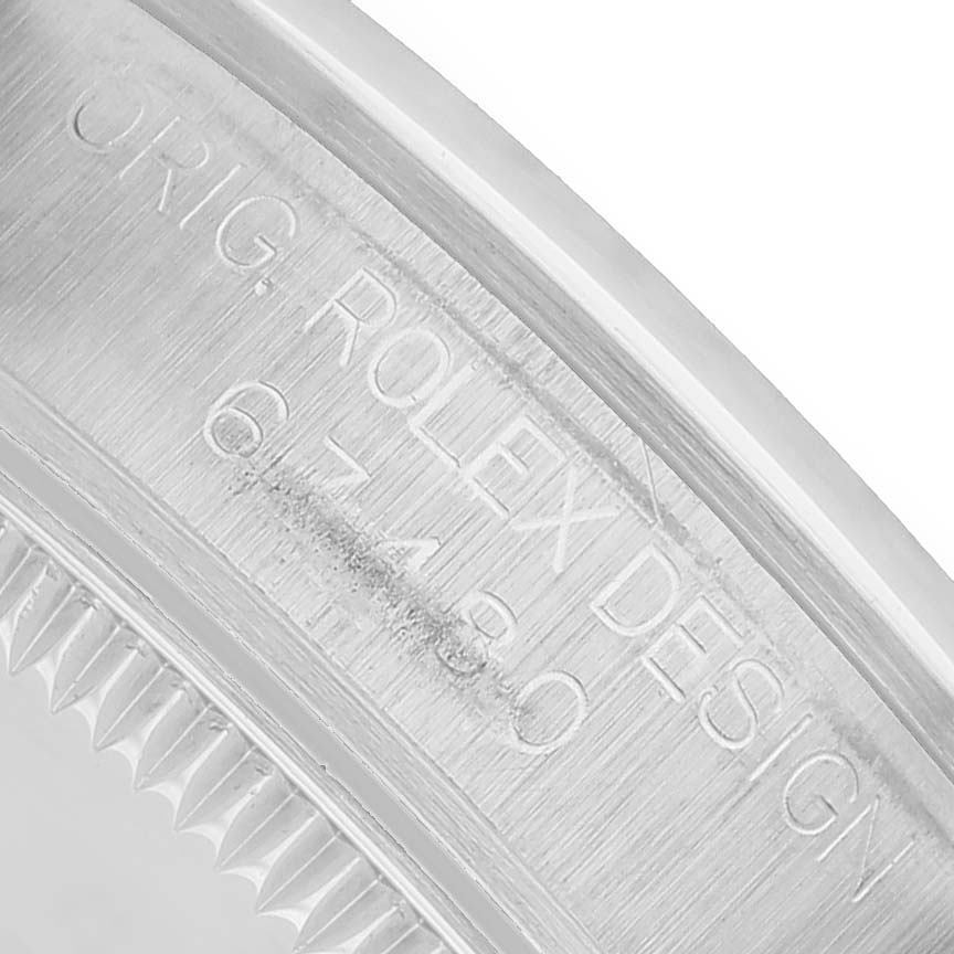 The image shows a close-up of the engraving on the side of the bezel of a Rolex Oyster Perpetual 67480 Women's Stainless Steel Pink Dial watch.
