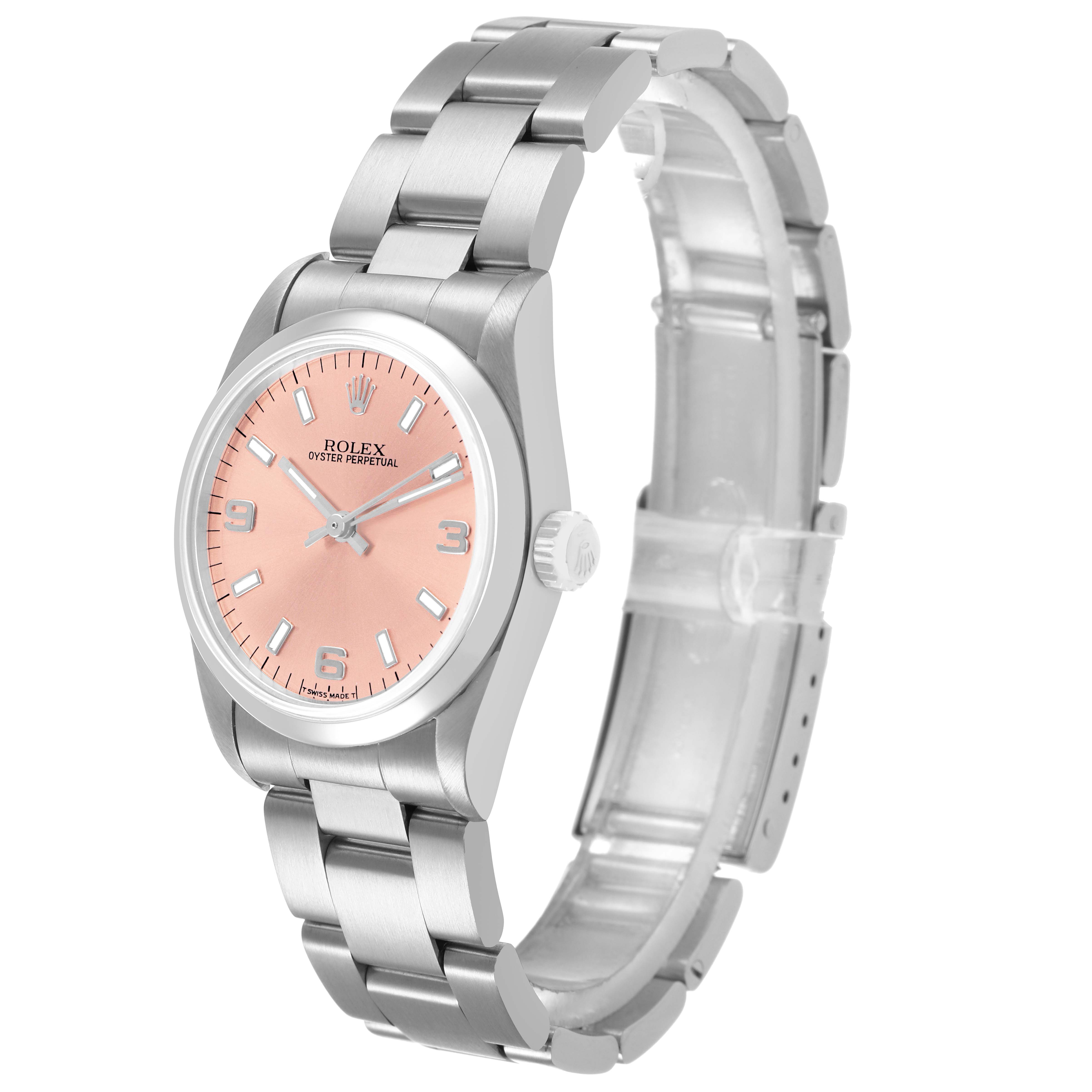 The Rolex Oyster Perpetual 67480 Women's Stainless Steel Pink Dial watch is shown from a three-quarter angle, highlighting the pink dial, bezel, crown, and bracelet.