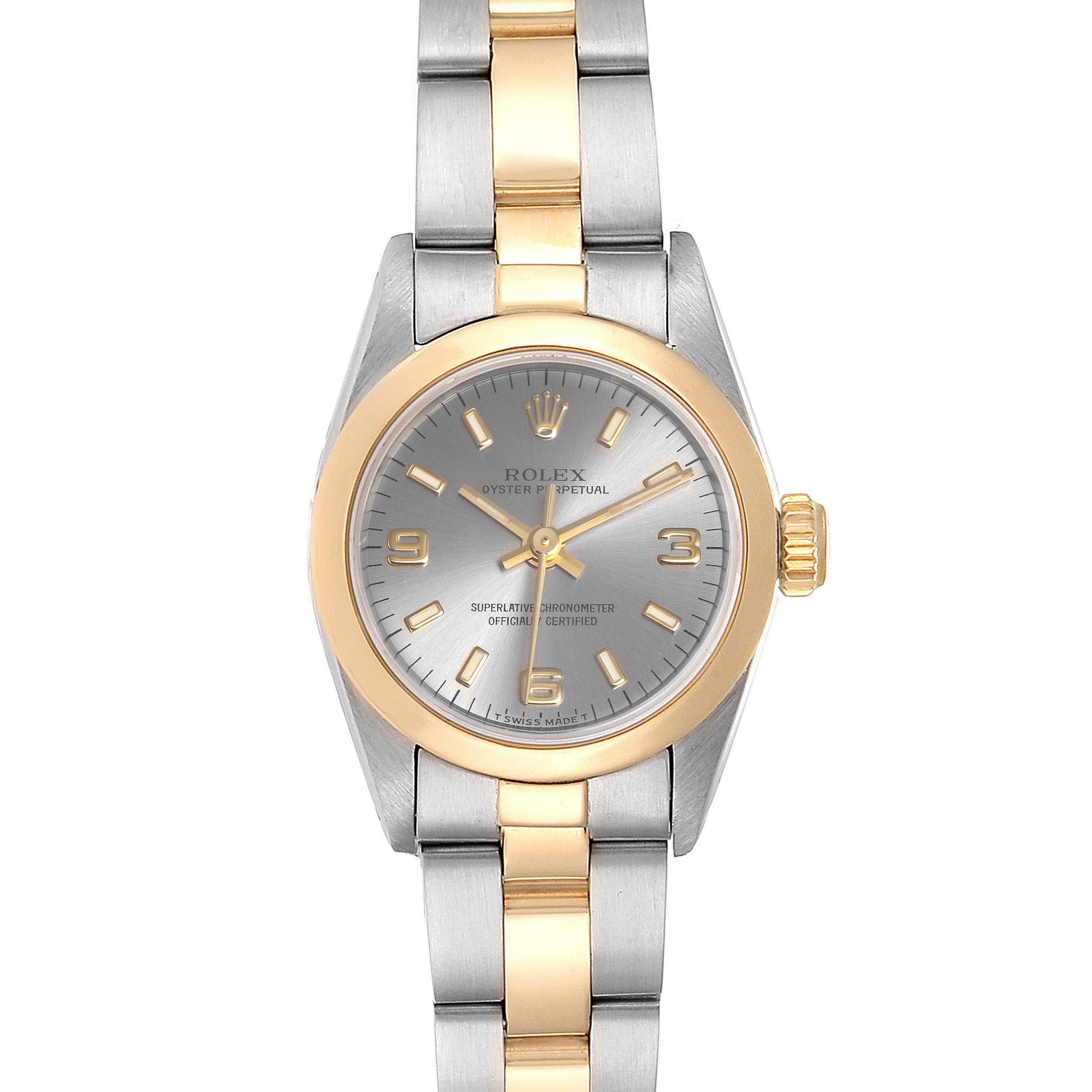 This image shows a Rolex Oyster Perpetual 67183 Women's Steel and Gold (two tone) Grey Dial 67183 Women's Steel and Gold (two tone) Grey Dial watch with a silver dial, gold accents, and a two-toned metal bracelet, viewed from the front.
