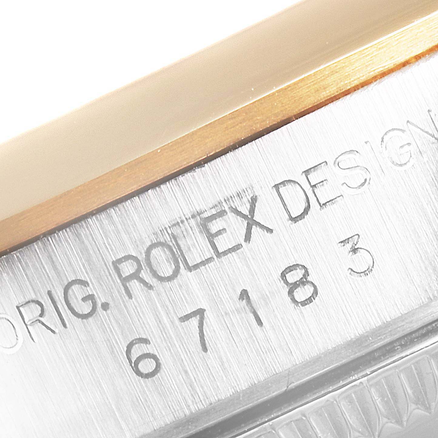 This image shows a close-up of the serial number engraving on the case of a Rolex Oyster Perpetual 67183 Women's Steel and Gold (two tone) Grey Dial 67183 Women's Steel and Gold (two tone) Grey Dial watch.
