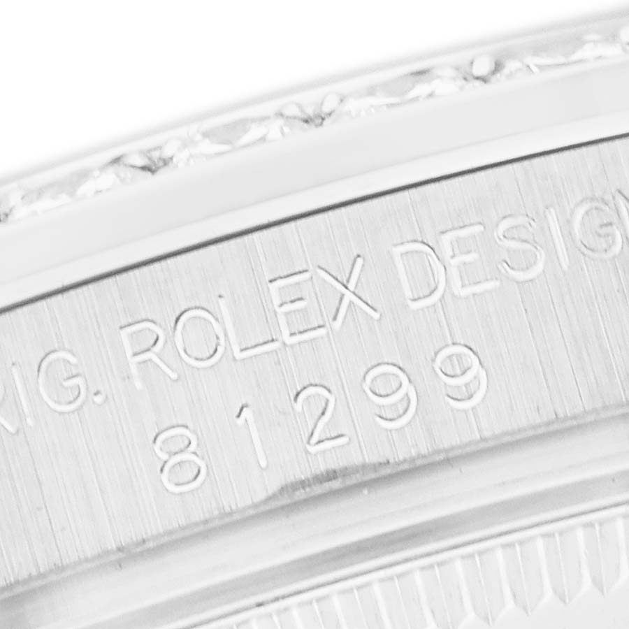 The image shows the engraved side of the Rolex Pearlmaster 81299 Women's White Gold Mother of Pearl Dial, featuring its design numbers.