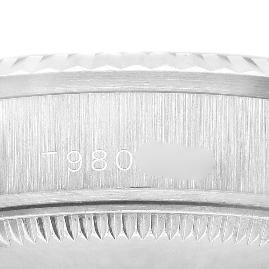 The image shows a close-up side view of the Rolex Datejust 68279 Women's White Gold Silver Dial's fluted bezel and part of the engraved case side.