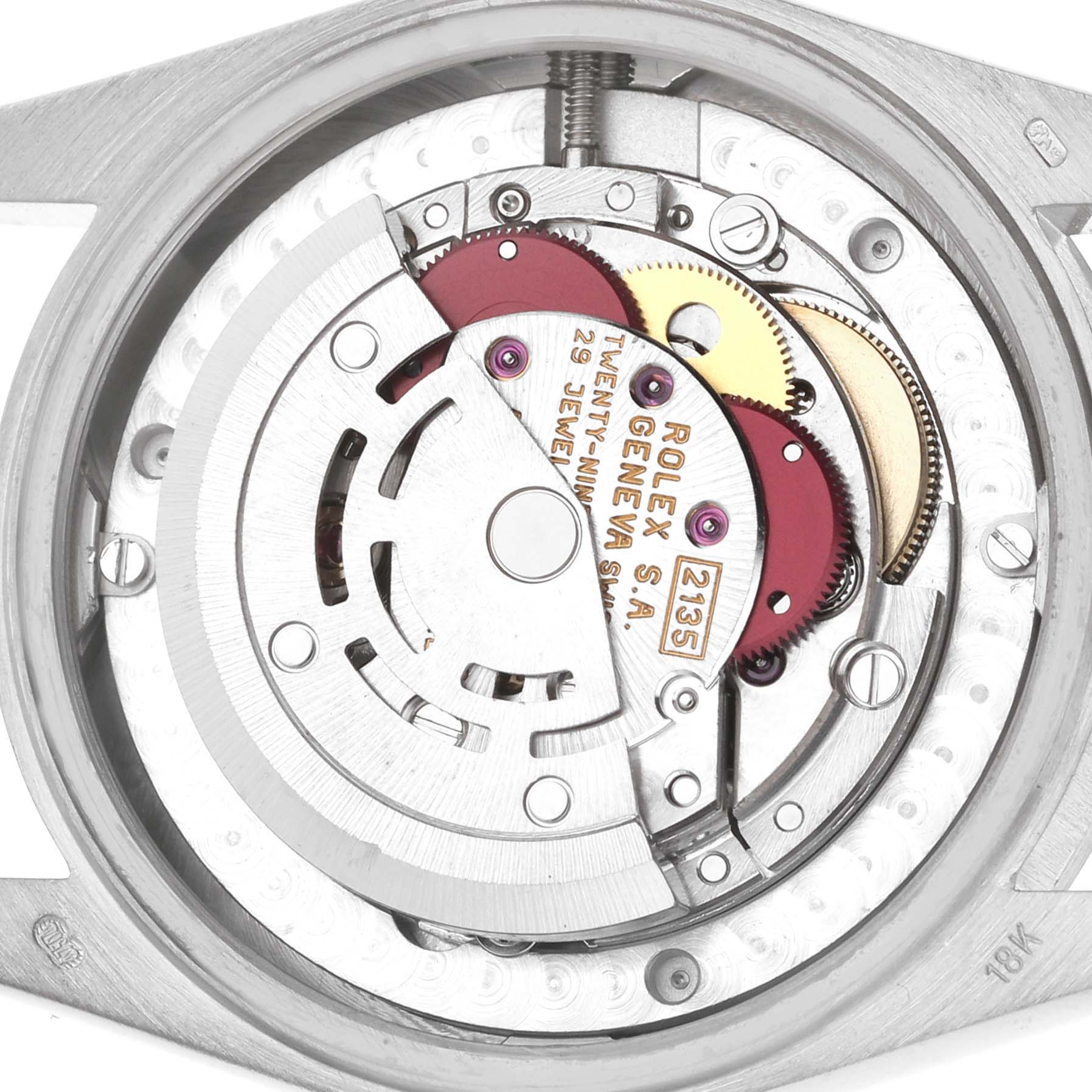 The image shows the inner movement mechanism of a Rolex Datejust 68279 Women's White Gold Silver Dial watch, highlighting gears and the rotor.
