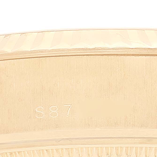 This close-up image shows part of the gold bezel and the inside engraving of a Rolex President 69178 Women's Yellow Gold Champagne Dial 69178 Women's Yellow Gold Champagne Dial model watch.