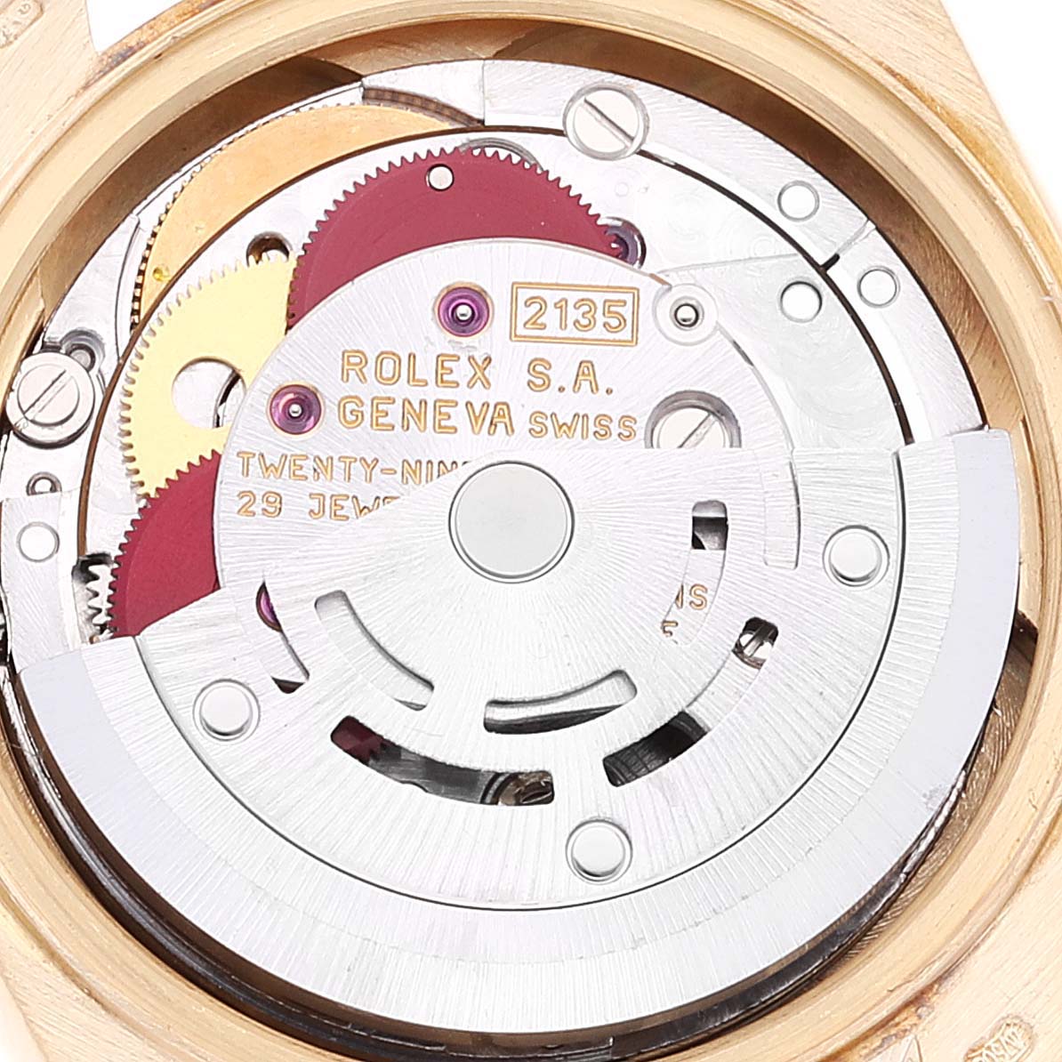 The image shows the internal mechanism of a Rolex President 69178 Women's Yellow Gold Champagne Dial 69178 Women's Yellow Gold Champagne Dial model watch from a back angle, highlighting gears and jewels.