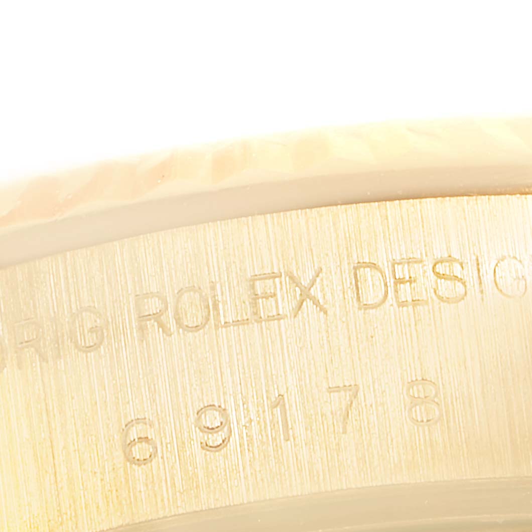 This image shows a close-up view of the case side engraving on a Rolex President 69178 Women's Yellow Gold Champagne Dial 69178 Women's Yellow Gold Champagne Dial model watch.