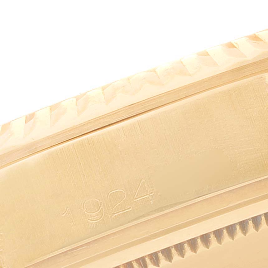 The image shows a close-up of the side of a Rolex Vintage Collection 1803 Men's Yellow Gold Champagne Dial 1803 Men's Yellow Gold Champagne Dial model, highlighting its case engraving and fluted bezel.