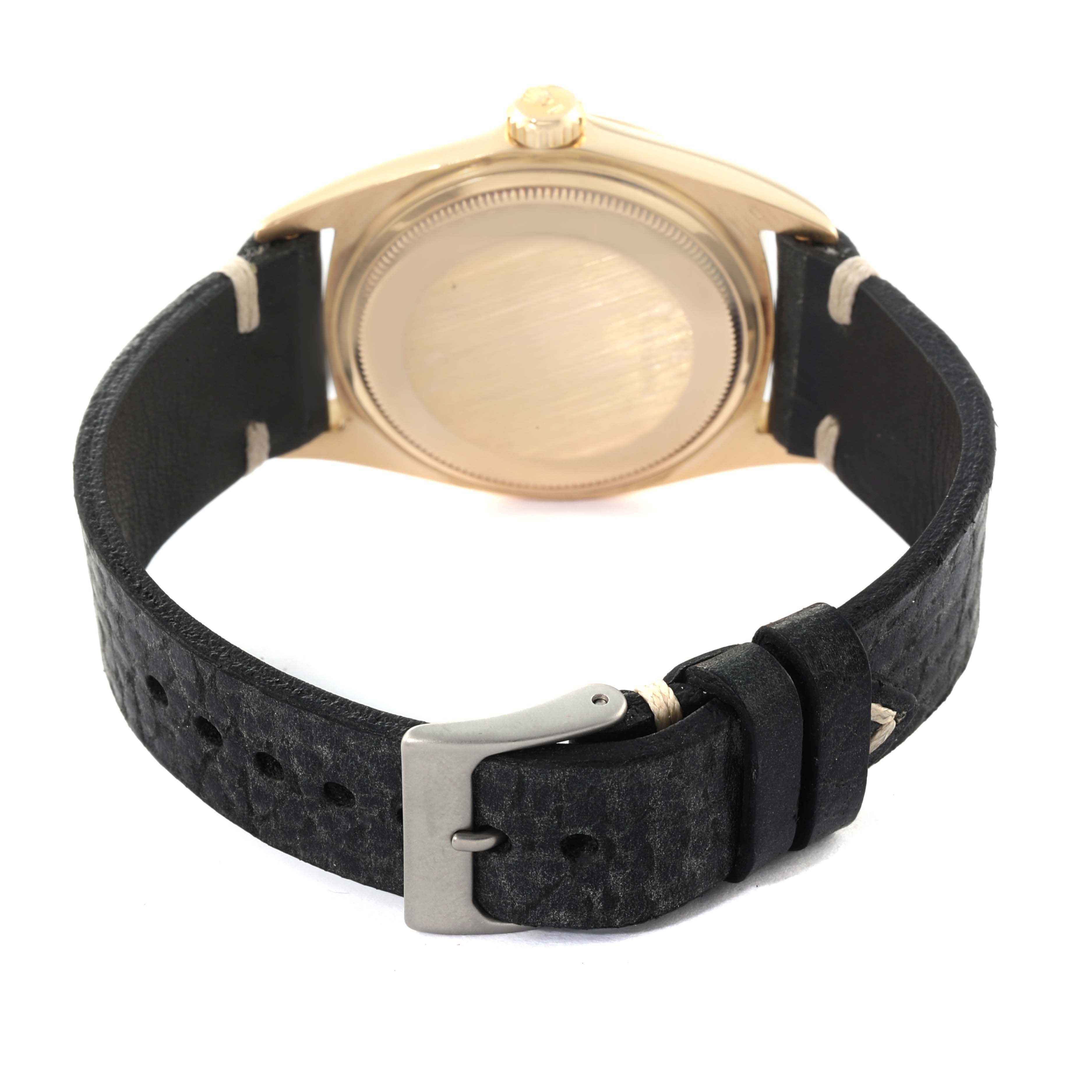 The image shows the back of a Vintage Collection Rolex watch, highlighting its case and leather strap with a buckle.