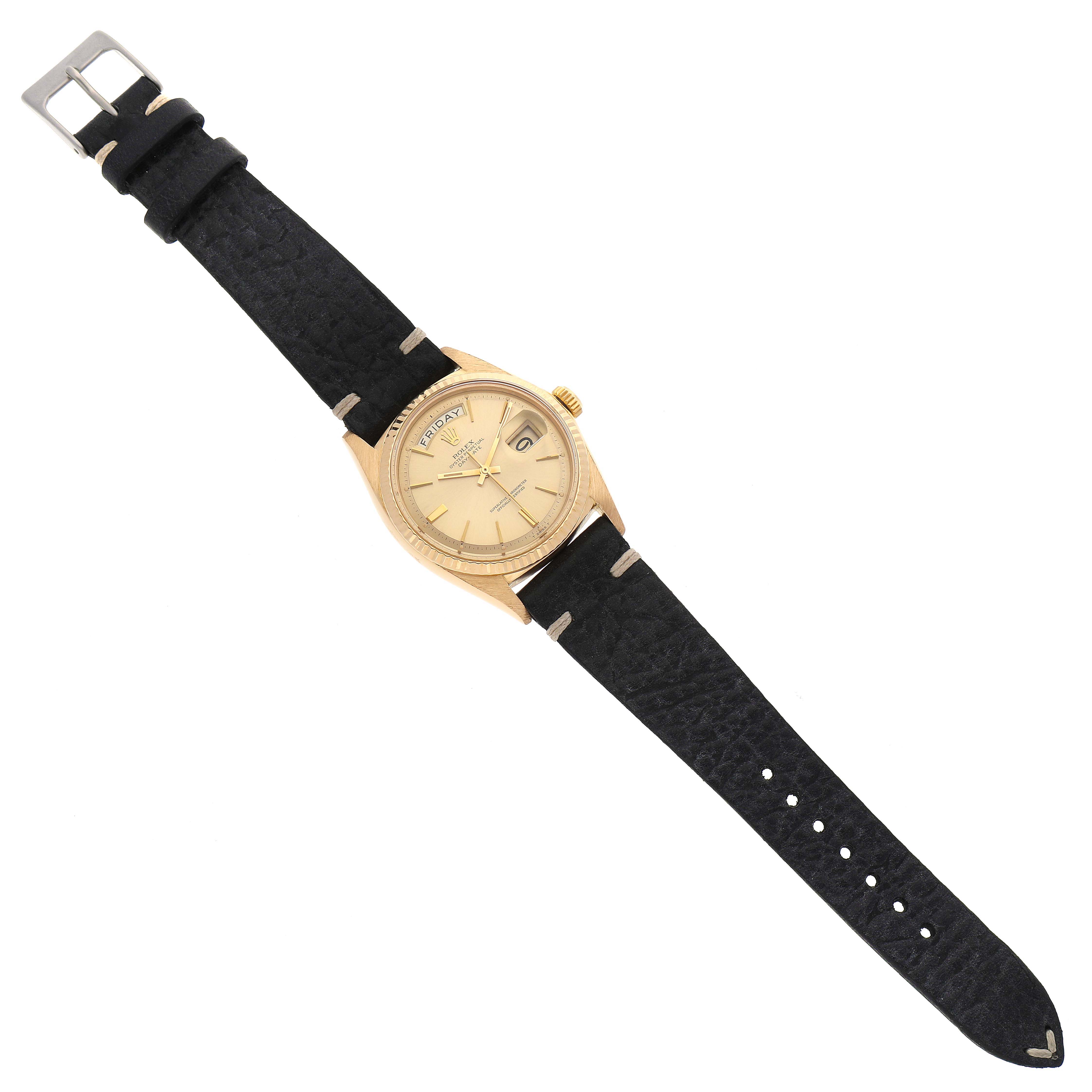 This Rolex Vintage Collection 1803 Men's Yellow Gold Champagne Dial 1803 Men's Yellow Gold Champagne Dial watch is shown from a top-down angle, fully displaying the face, black strap, and metal buckle.