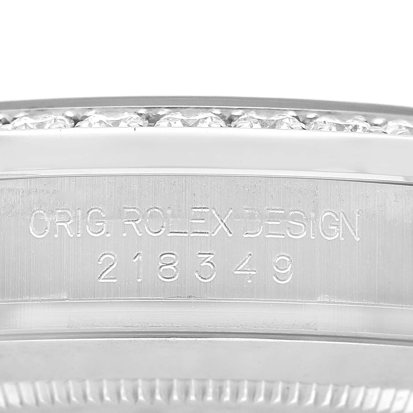 The image shows the engraved side of a Rolex President 218349 Men's White Gold Silver Dial model bezel with diamond detailing.