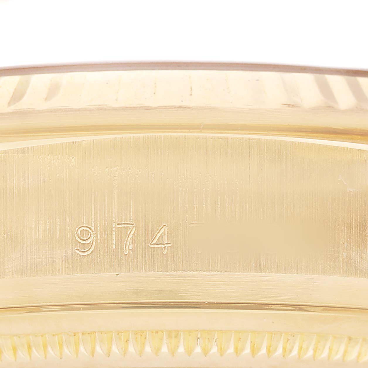 This image shows a close-up of the side of a Rolex President 18038 Men's Yellow Gold Champagne Dial model watch, focusing on the case with visible engraving.