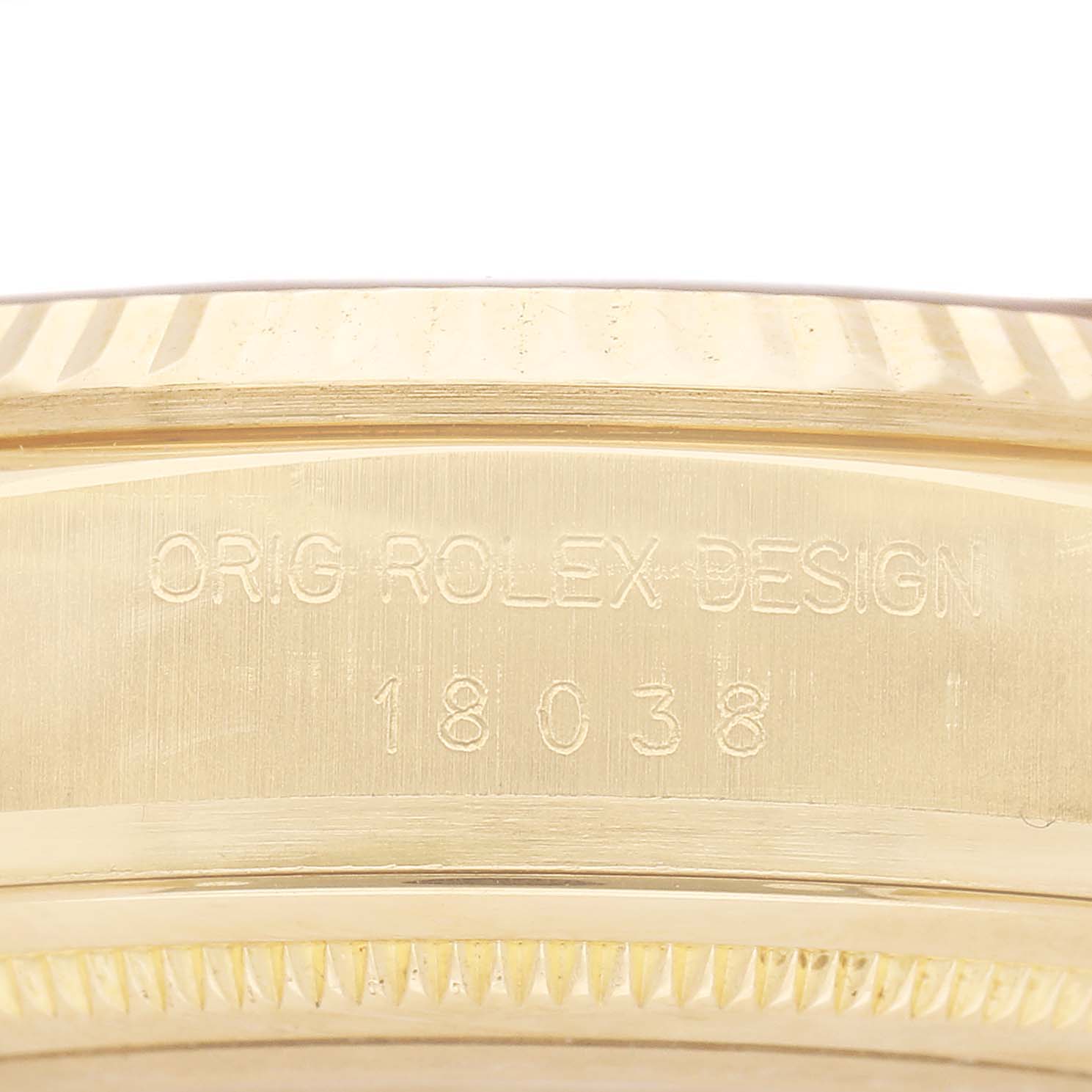 The image shows a close-up of the side of a Rolex President 18038 Men's Yellow Gold Champagne Dial model, focusing on the engraved design details.