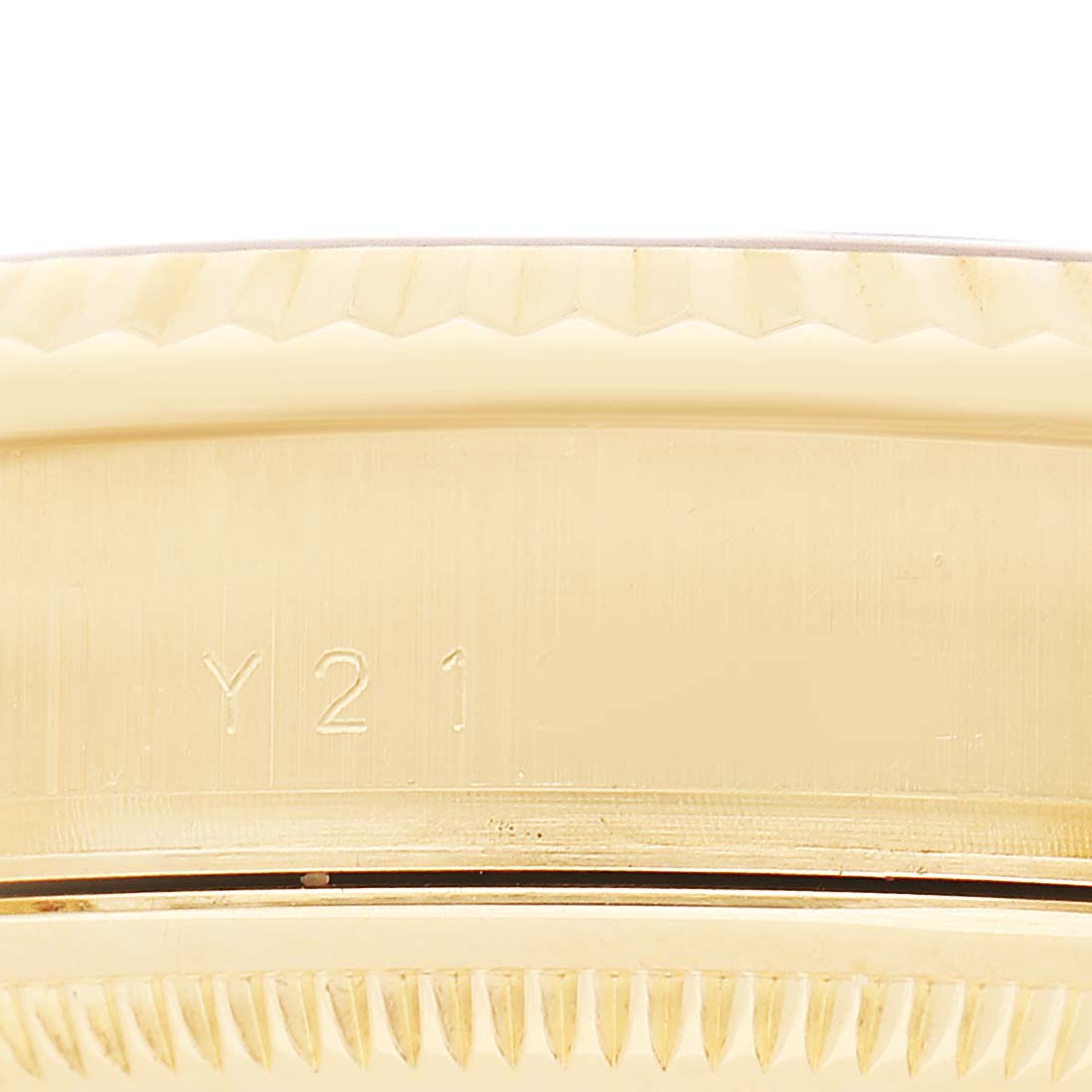 This image shows a close-up of the side of the bezel with engraving on the Rolex President 36 Men's Yellow Gold Silver Dial watch.