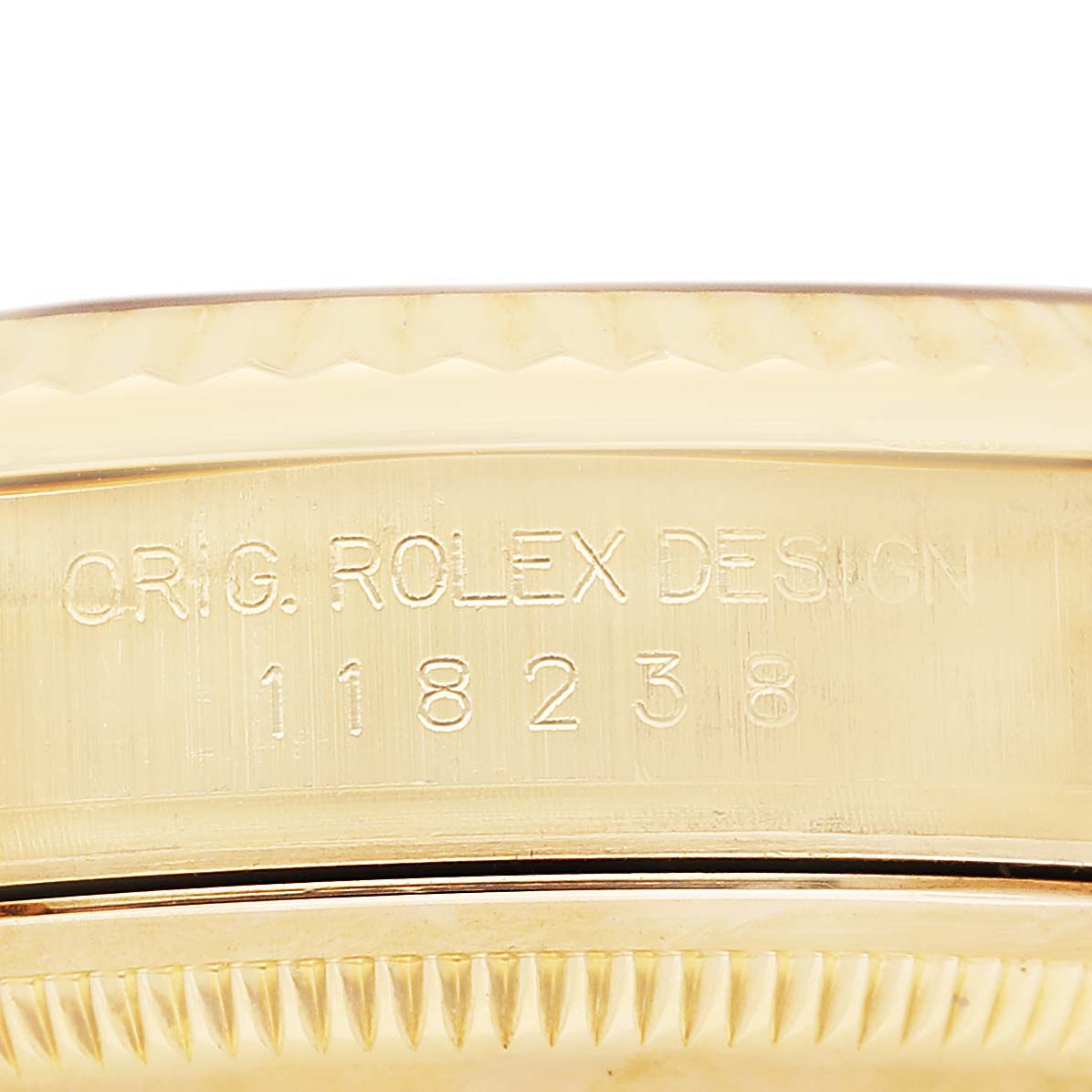 The image shows the side of a Rolex President 36 Men's Yellow Gold Silver Dial model, focusing on the engraved serial number and "Orig. Rolex Design" text.
