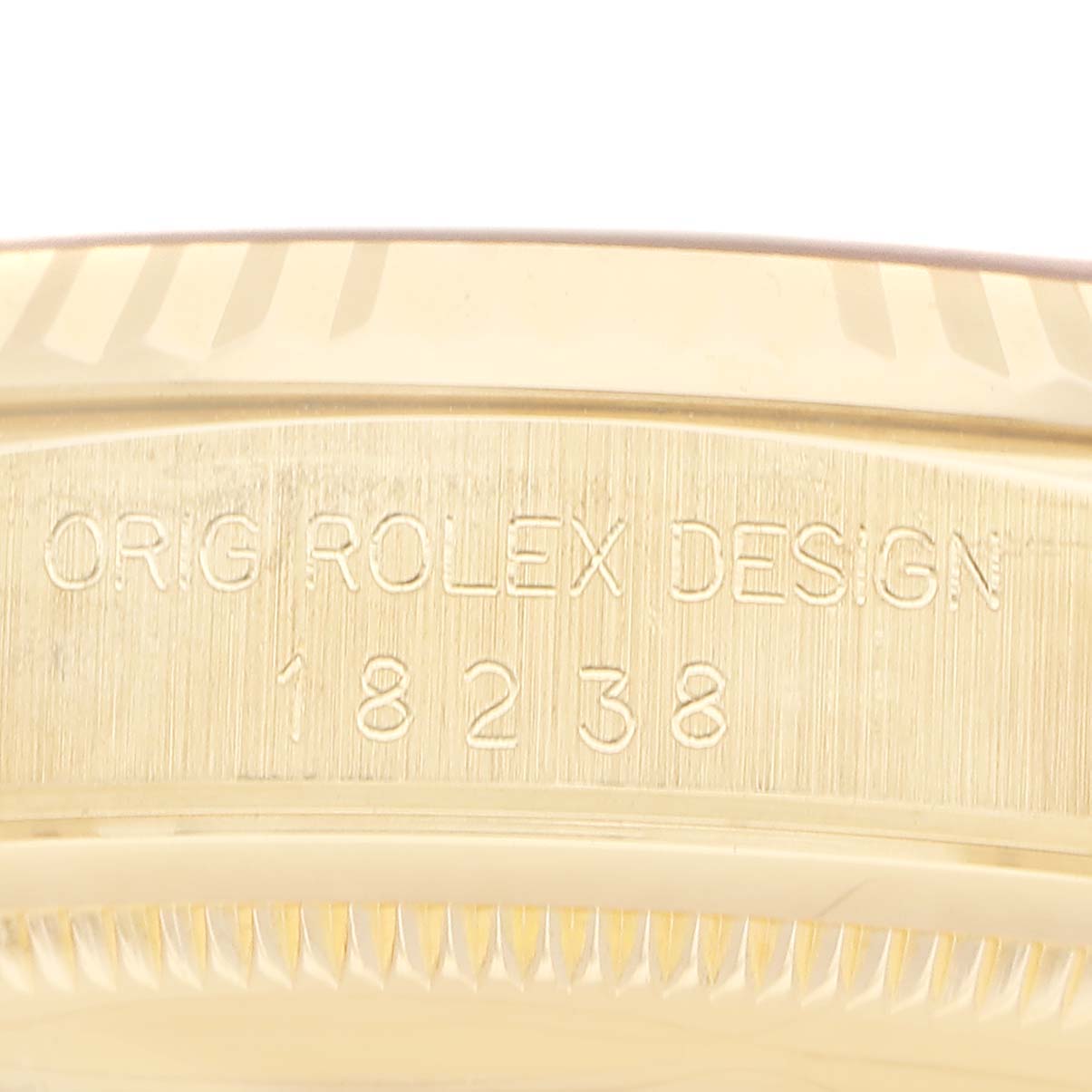 The image shows the side engraving on a Rolex President 18238 Men's Yellow Gold Champagne Dial model, displaying "ORIG ROLEX DESIGN" and model number "18238."